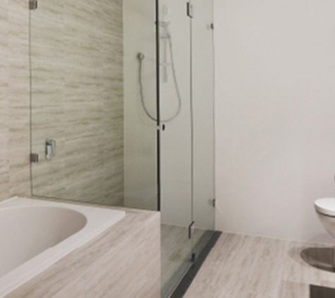 Bradnam's Windows & Doors - Mount St John, QLD. Frameless Shower Screen Next To A Bath