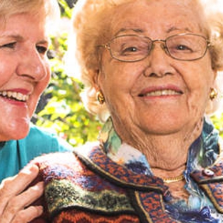 Amana Living - Cottesloe, WA. A resistent with her carer outdoors