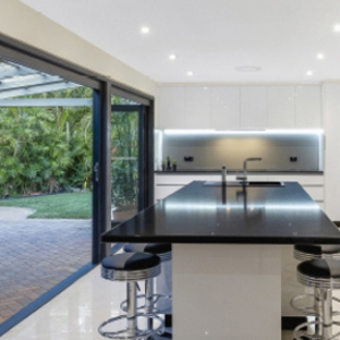 Bradnam's Windows & Doors - Bungalow, QLD. Black Aluminium Bi-Fold Doors