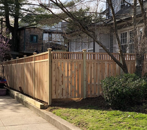 Serrano Fence & Son, Inc. - Island Park, NY. semi privacy cedar wood sections with closed spindle topper and 6x6 treated retaining wall