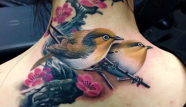 7 Train Tattoo Studio Inc. - Flushing, NY. Realistic bird tattoo # Cover up tattoo #Cherry blossoms and bird tattoo