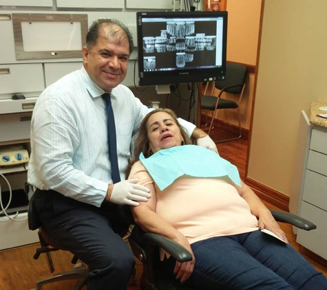 Grand Prairie Family Dental - Grand Prairie, TX. Dr. Behrooz Khademazad with dental implant patient at Grand Prairie Family Dental