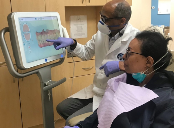 Premier Dental Care - Washington, DC. Washington DC dentist Dr. Daniel Hines explaining dental crown options at Premier Dental Care